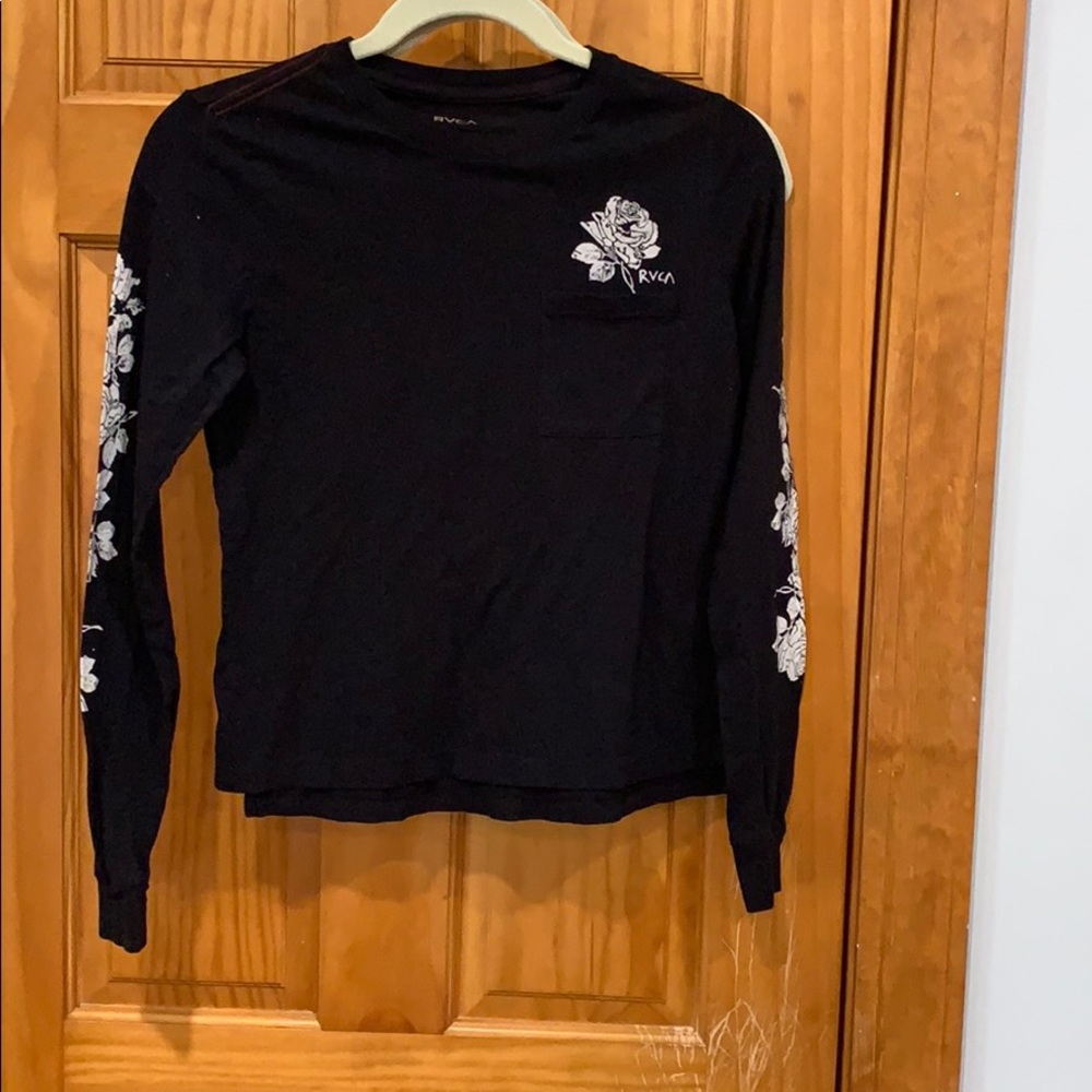 Black Top with flowers on the sleeves and pocket.